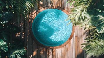 An aerial view of a beautiful circular swimming pool surrounded by lush greenery, inviting relaxation and tranquility in a luxurious outdoor environment. photo