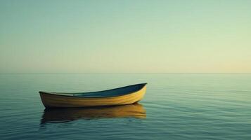A solitary yellow boat floats peacefully on a calm water surface, symbolizing tranquility and solitude within an expansive, serene environment. photo