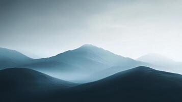 Dark, undulating mountains create a mystic ambiance as fog envelops the landscape, evoking a sense of mystery and the unknown in this captivating view. photo