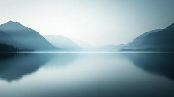 This breathtaking image showcases misty mountains reflected in still water, creating a mesmerizing and peaceful visual experience, perfect for nature lovers and dreamers. photo