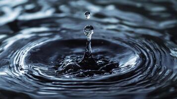An exquisite moment captured of a water droplet falling into dark water, creating mesmerizing concentric ripples that evoke tranquility and calmness. photo