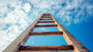 Ladder reaching toward a vibrant blue sky filled with scattered clouds, symbolizing ambition, progress, and opportunities ahead. photo