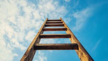 Ladder ascending towards a partly cloudy sky, symbolizing aspiration, achievement, or progression under an open, expansive sky. photo