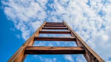 Ladder against a blue sky, climbing towards the heavens symbolizing hope, ambition, and success in achieving goals and fulfilling dreams. photo