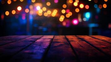 A rustic wood table in the foreground bathed in colored light, with bokeh in the background suggesting an outdoor venue at night. photo