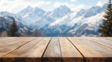 Wooden tabletop display against a blurred background of snowy mountains and coniferous trees. Ready for product placement or scenic backdrop. photo