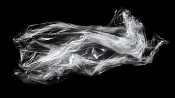 Translucent wrapping material on dark background. Delicate folds and refractions creating a sculptural, abstract presentation. photo