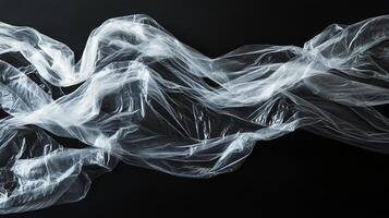 Abstract view of plastic sheeting against a dark backdrop, creating a ghostly ethereal atmosphere. The image evokes a sense of movement. photo