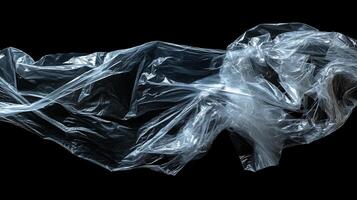 Abstract composition of translucent plastic against a stark black background, highlighting texture and the interplay of light and shadow. photo