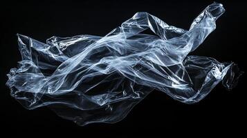 Translucent folds catch the light, creating an ethereal sculpture against the dark canvas, whispering tales of fragility and waste. photo