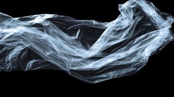 Floating translucent plastic sheet against a void, captured in dynamic lighting and emphasizing its fragile texture and undulating form. photo