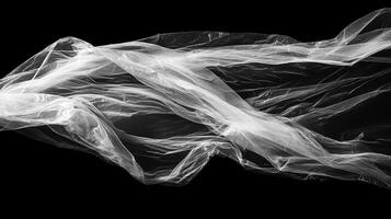 Abstract monochrome composition of light passing through translucent material over a dark void. Ethereal waves texture. photo