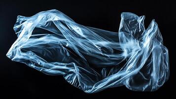 Floating translucent material with blue highlights against a dark void, creating ethereal and abstract imagery. The shape is unknown. photo