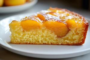 Slice of delicious homemade peach cake resting on white plate photo