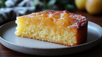 Slice of pear and almond cake resting on a plate photo