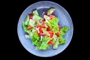 Fresh Vietnamese salad with vegetables on the black background side view photo