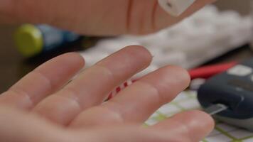 Woman checks blood sugar level with a glucometer using a pen device video