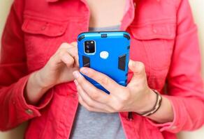 Mobile phone in hand. Woman using a phone photo