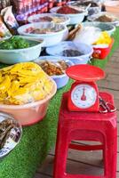 scales in the Vietnamese market for weighing dried fruits and snacks photo