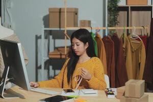 A woman is working on a computer in an office photo