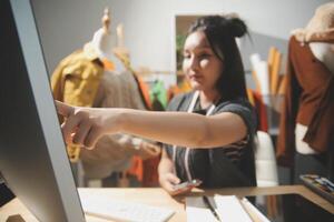 A woman is using a computer to make a purchase photo