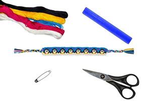 Woven friendship bracelet with acute pattern Penguins hold their paws. All set for making the friendship bracelet scissors, floss thread, ruler, pin photo