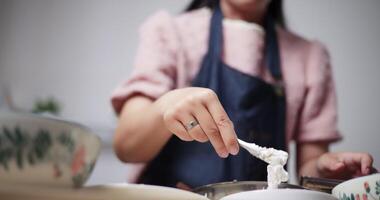 Hands of woman is preparing the process of coating chicken with all the ingredients in a bowl before frying the chicken on a pan. Cooking concept, Food preparation video