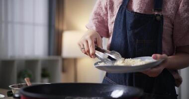 Hands of Beautiful woman frying crispy chicken with hot oil on electric pan on table at home. Cooking concept, food preparation. video
