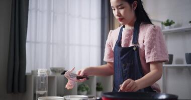 Handheld shot, Beautiful woman marinating chicken with all ingredients in bowl and mixing ready to make fried chicken at home. food preparation. video