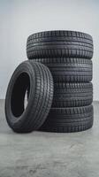 Stack of tires with one leaning wheel isolated on white background photo