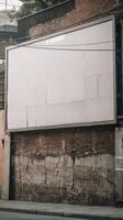 A billboard on a brick wall in front of a building photo