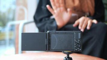 Woman in interview, using a small camera video