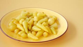 Fresh yellow chili peppers arranged colorfully on a plate video