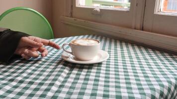 Coffee served in a charming cafe with a checkered tablecloth video