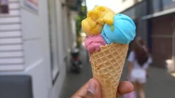 Brightly colored ice cream cone enjoyed on a sunny afternoon video