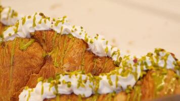 Delicious pastry topped with cream and pistachios in a cafe setting video