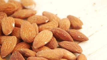 Almonds showcased on wooden surface with light background video