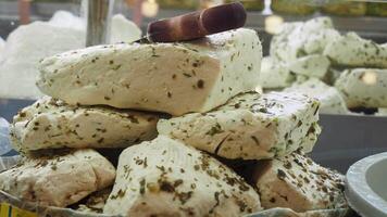 Fresh cheese blocks with herbs displayed in local market stall video