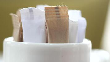 Sugar packets in a white container video