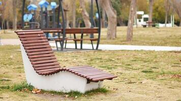 Relaxing view of a park lounge chair surrounded by trees video