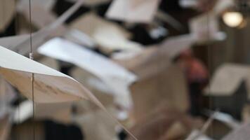 Floating papers create an artistic atmosphere in a gallery video