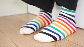 Colorful striped socks on display in a cozy indoor setting video