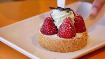 Delicious strawberry tart creation in a vibrant bakery setting video