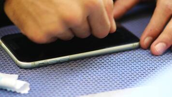 Repairing a smartphone screen in a busy service center video