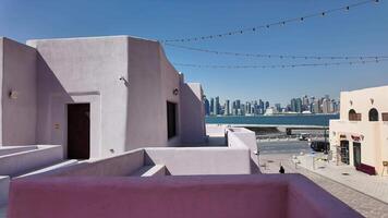 Qatar Doha 2 february 2025, Colorful architecture in desert town under clear blue sky at mina district video