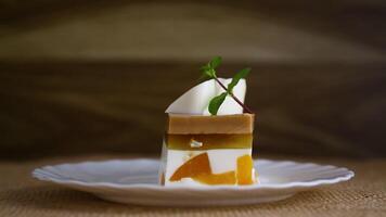 milk fruit jelly dessert with pieces of fruit inside, in a plate . video