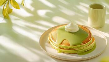 Sweet pancake stack with matcha cream topping on plate for simple breakfast photo