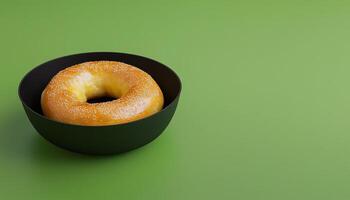 Bagel fried ring dough bread on black paper bowl with copy space green background photo