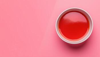 Tomato sauce red cream on bowl copy space pink background photo