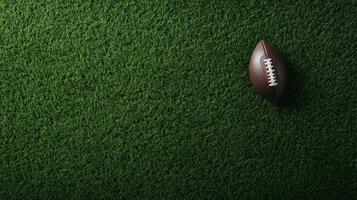Aerial view of a brown leather ball with white stitching on the side, resting on green grass photo